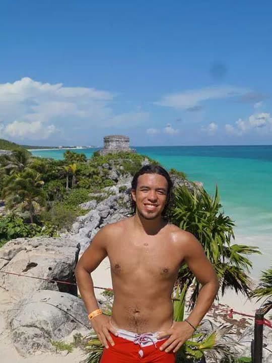 Standing at the Tulum clifftop ruins with the Caribbean behind